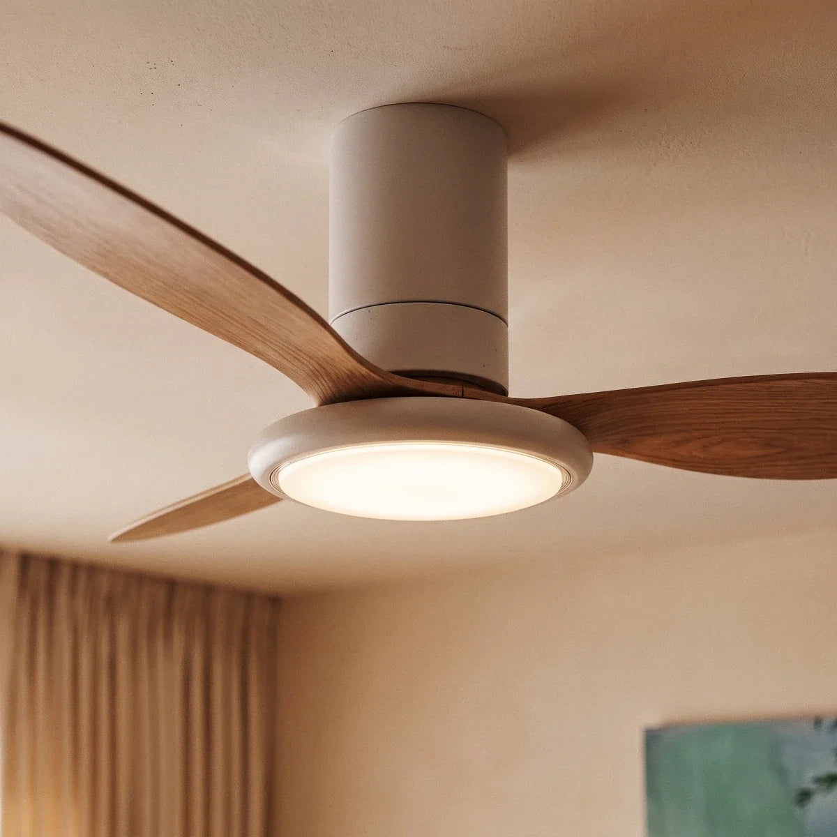 Close up of the Clérachic white ceiling fan with a light: wood-grain blades, a slim white motor and a glowing round LED disc.