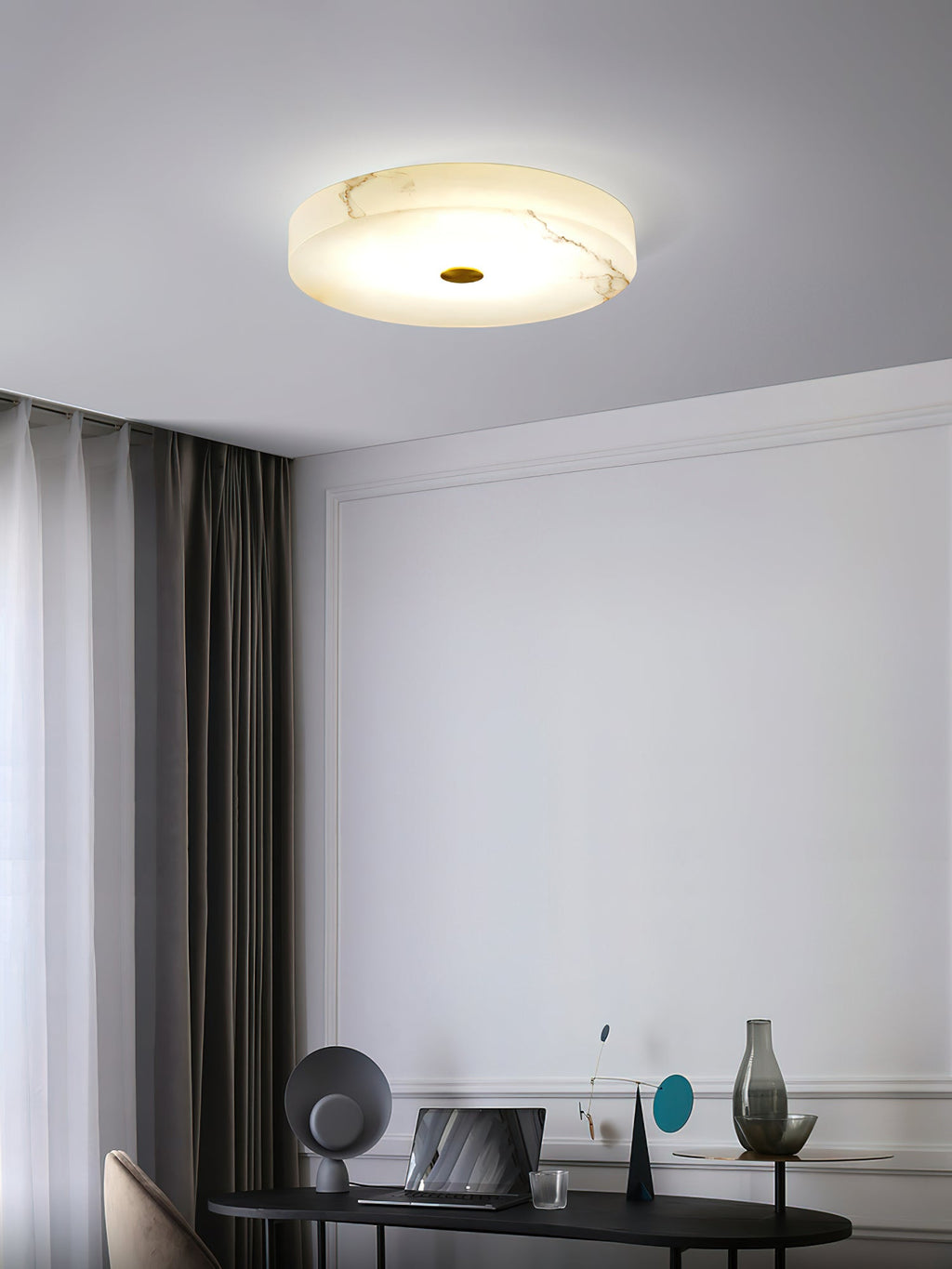 Clérachic drum ceiling light over a study corner, warm light spreading across the veined alabaster above a desk and laptop.