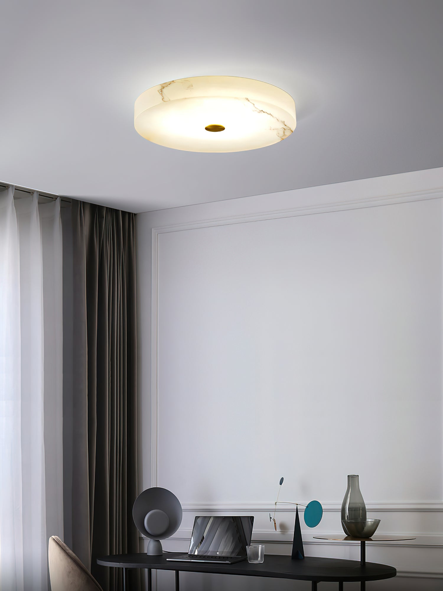 Clérachic drum ceiling light over a study corner, warm light spreading across the veined alabaster above a desk and laptop.