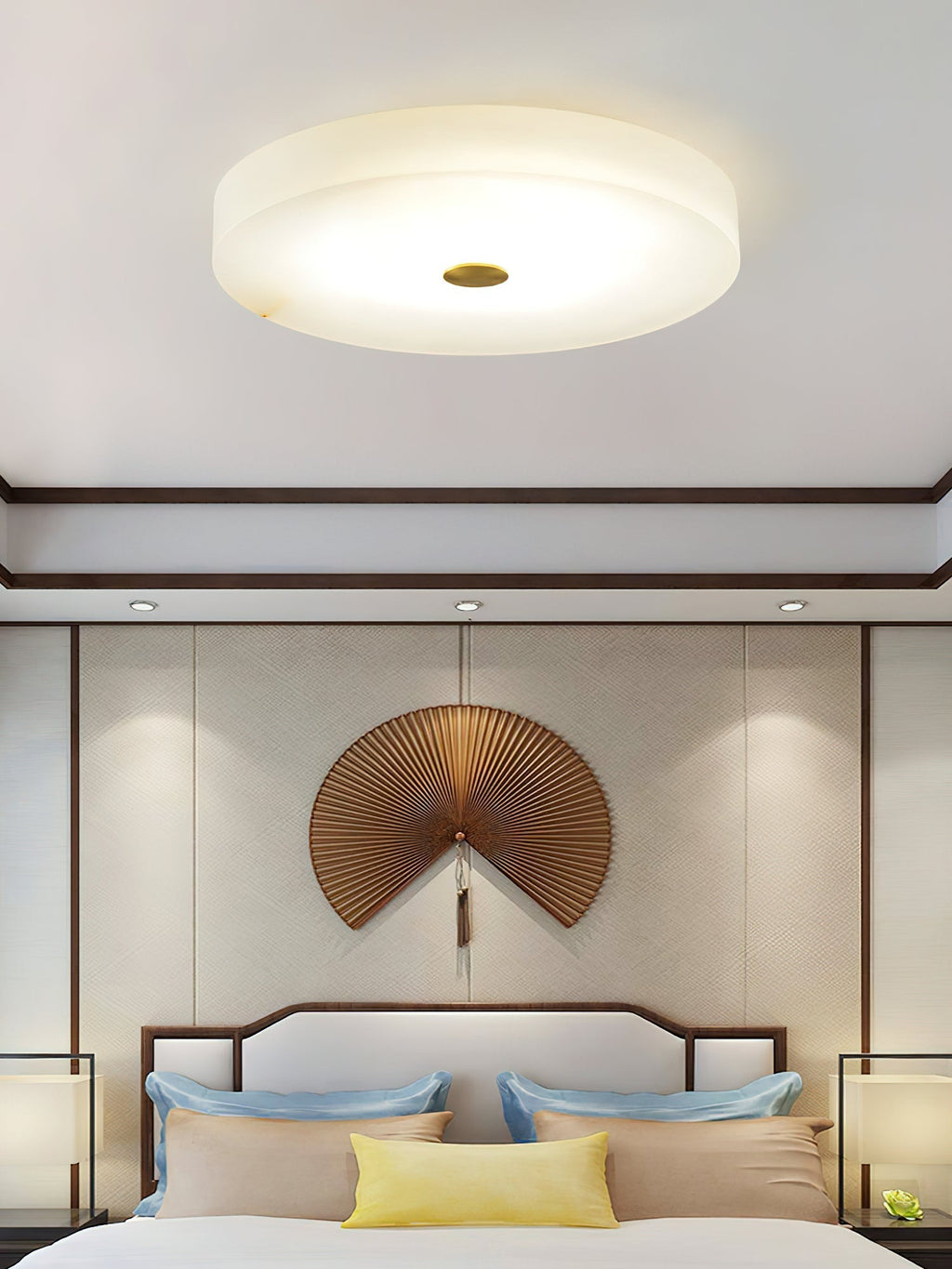 Straight-on view of the Clérachic drum flush mount ceiling light, its brass cap centred on a broad disc of glowing alabaster.