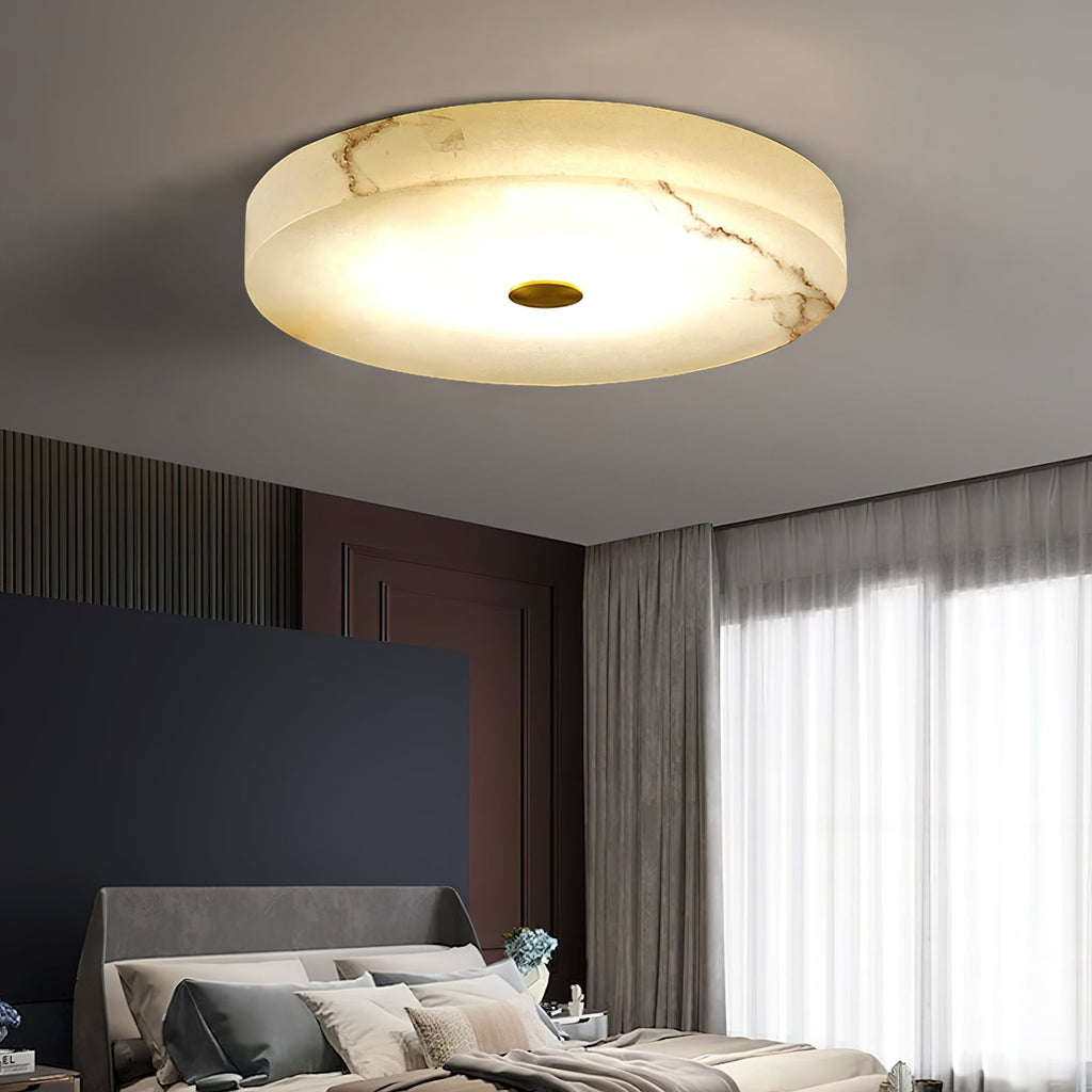 Angled view of the Clérachic flush mount ceiling light, tan veining running across the alabaster as the LED lights it from within.