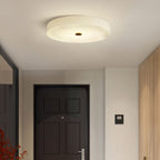 Clérachic alabaster ceiling light in an entrance hall, sitting flush over the front door where a hanging fixture would not clear.