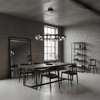 Ring chandelier from Clérachic with smoked glass shades above a dark dining table, in a loft room with grey brick walls and a tall window.