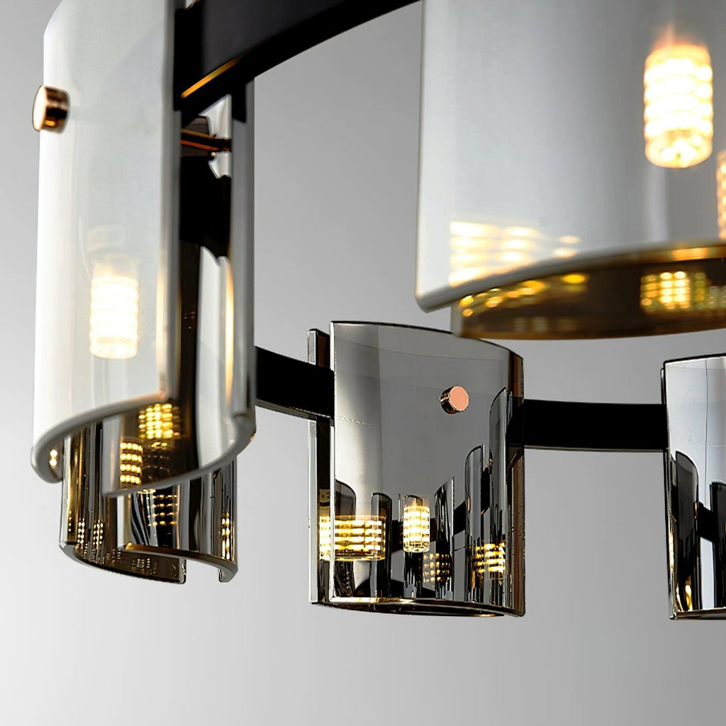 Close view of curved smoked glass shades on the black band of this Clérachic chandelier, with small bulbs glowing within.