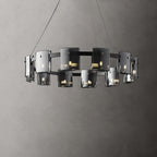 Black-frame ring chandelier from Clérachic with a double row of smoked glass shades, shown against a textured grey wall.