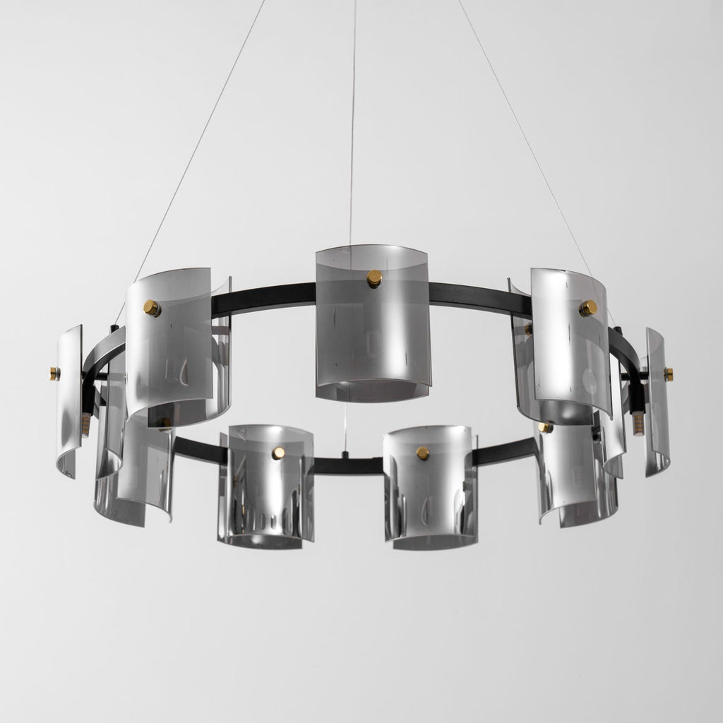Wide view of the black ring on this Clérachic chandelier, with smoked glass cylinders hung in two rows on thin cables.