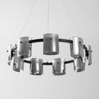 Wide view of the black ring on this Clérachic chandelier, with smoked glass cylinders hung in two rows on thin cables.