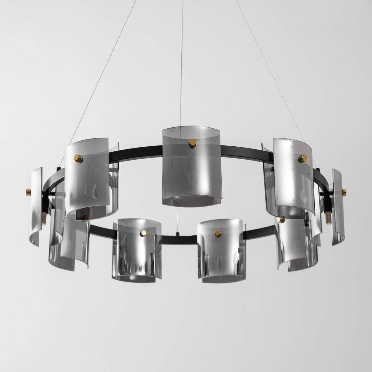Wide view of the black ring on this Clérachic chandelier, with smoked glass cylinders hung in two rows on thin cables.