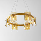 Gold-frame ring chandelier from Clérachic seen from below, with six amber glass shades lit and hung on thin cables.
