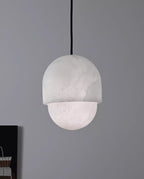 Clérachic Lunar pendant unlit on grey, matte alabaster reading soft white.