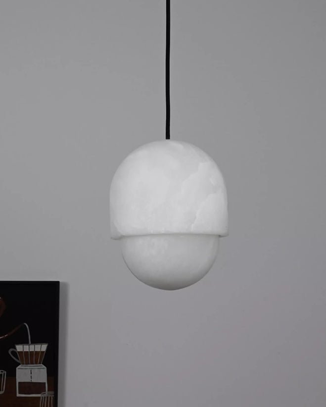 The Clérachic Lunar pendant unlit on grey, showing the seam between cap and diffuser.