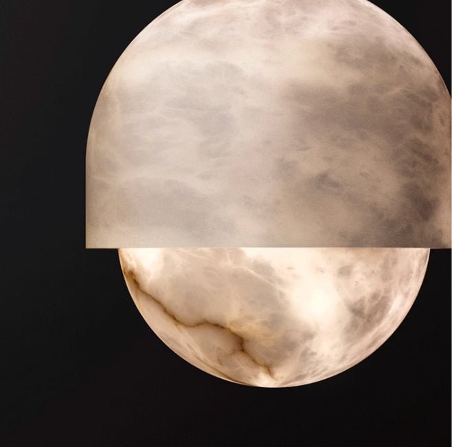 Macro of the Clérachic Lunar on black, cloudy alabaster glowing beneath the domed cap.