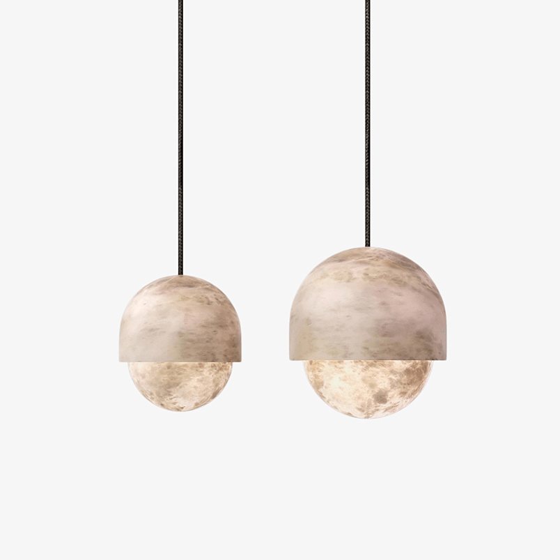 Two sizes of the Clérachic Lunar pendant shown together on white for scale.