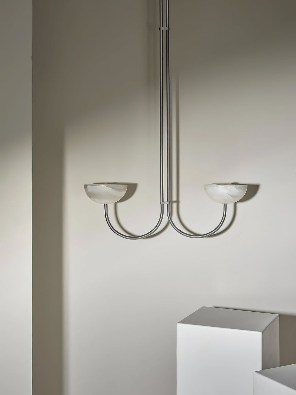 The Clérachic Lunaris pendant seen straight on, arms curving out from a single stem.