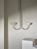The Clérachic Lunaris pendant seen straight on, arms curving out from a single stem.