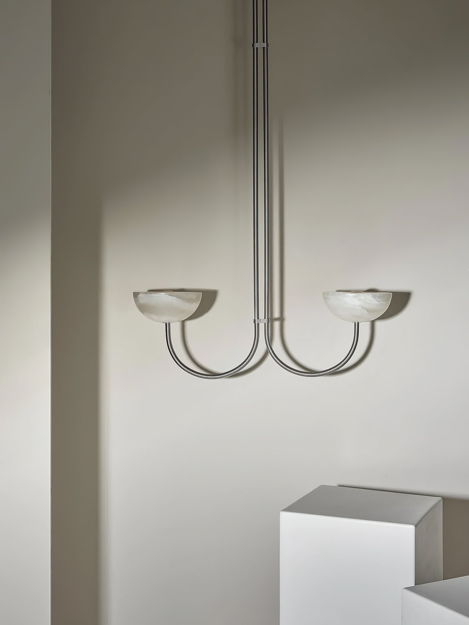 The Clérachic Lunaris pendant seen straight on, arms curving out from a single stem.
