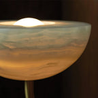 Macro of the Clérachic Lunaris bowl, warm light pooling in the veined alabaster dish.