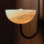 Close view of the Clérachic Lunaris bowl on a black arm, honeyed stone glowing within.