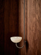 Clérachic Lunaris bowl in white finish against walnut, warm bulb visible in the dish.