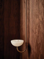 Clérachic Lunaris bowl on a brass arm, stone dish lit softly against walnut boards.