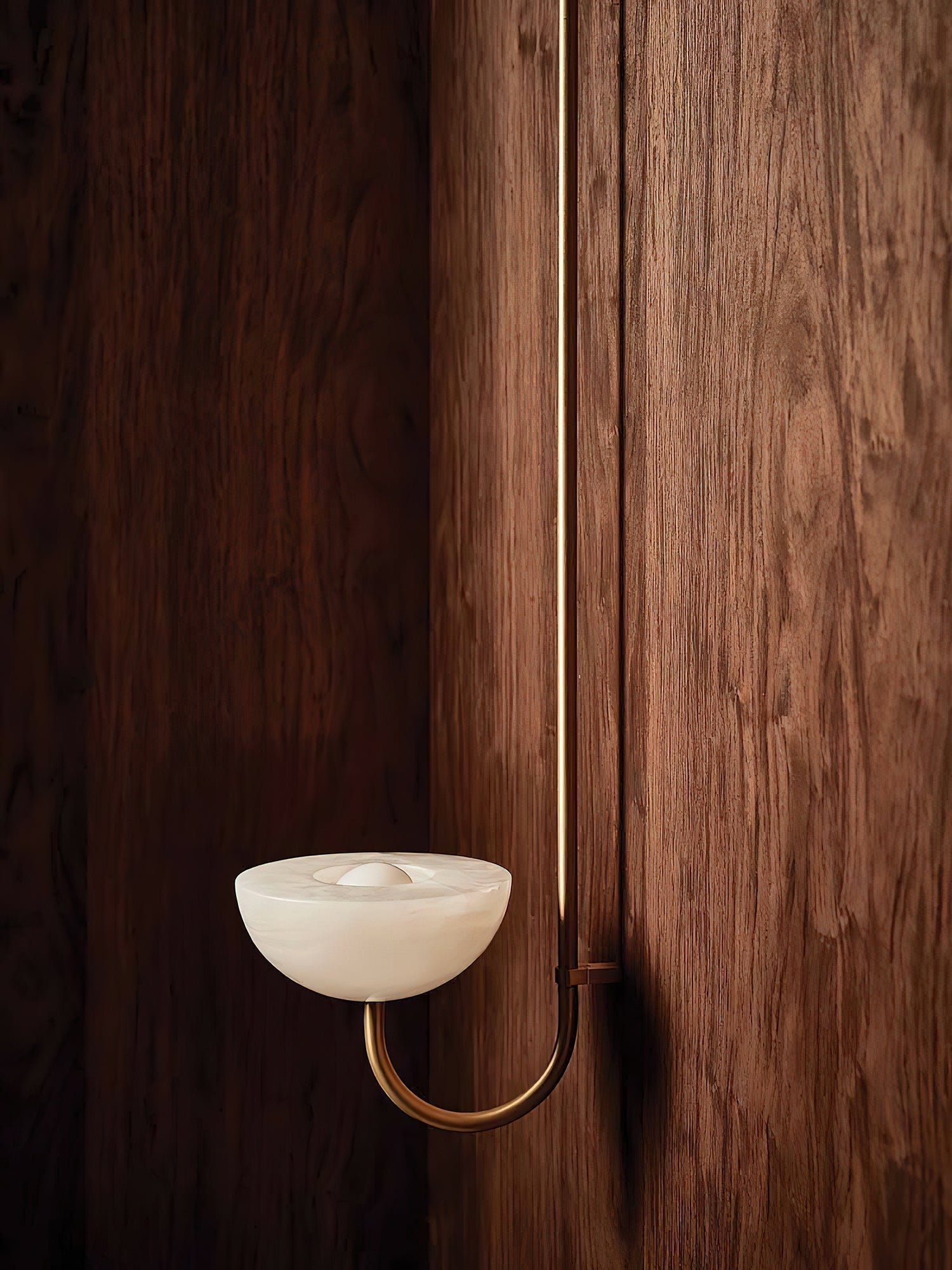 Clérachic Lunaris bowl on a brass arm, stone dish lit softly against walnut boards.