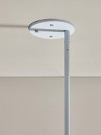Detail of the Clérachic Lunaris ceiling plate in white, stem fixed to the flat canopy.
