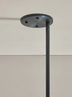 Detail of the Clérachic Lunaris ceiling plate in black with its fixing points visible.