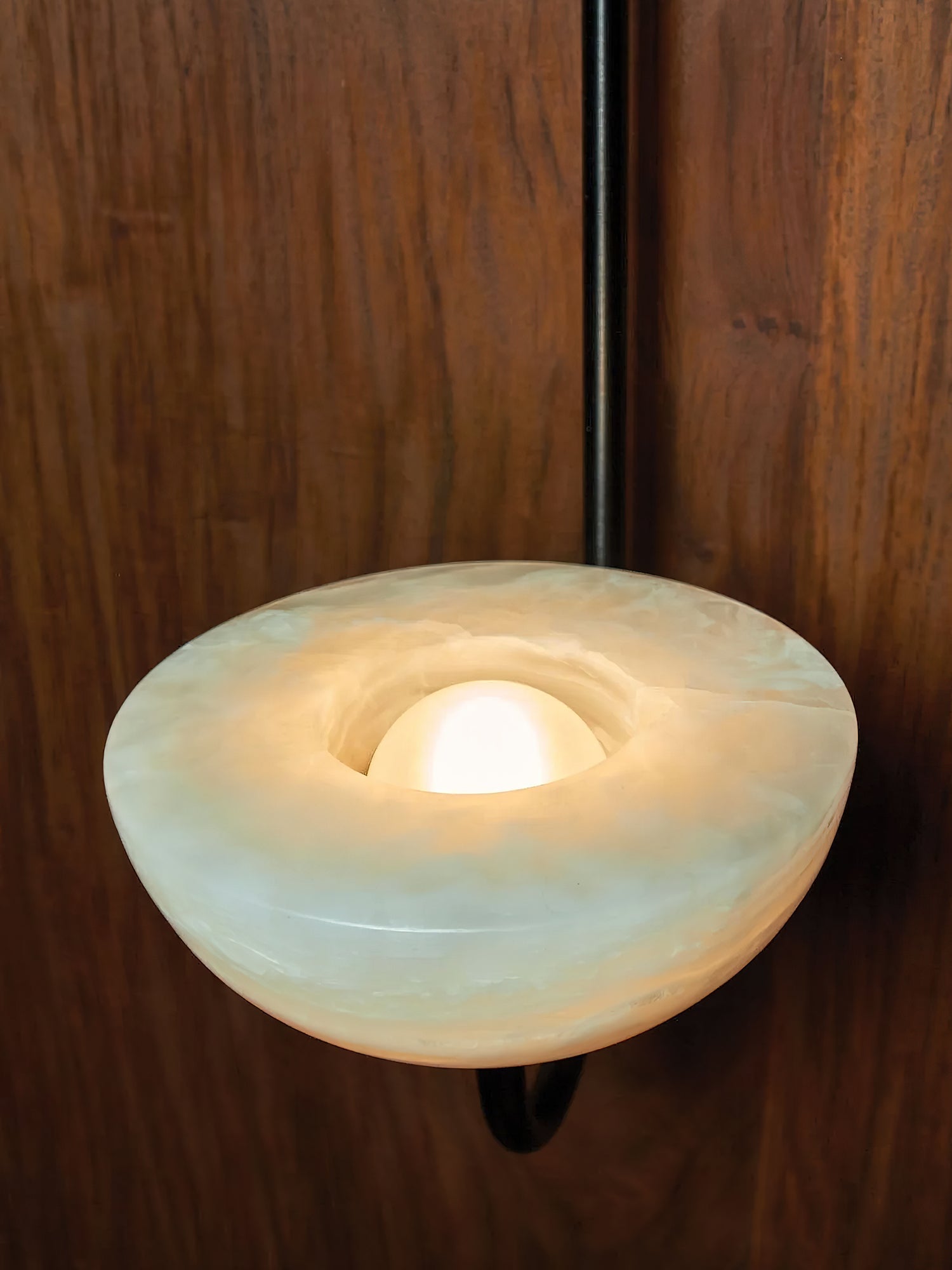 Macro of the Clérachic Lunaris bowl on black, pale green-white alabaster lit from inside.