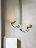 Clérachic Lunaris pendant in black, one bowl lit and the other left in shadow.