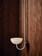 Clérachic Lunaris single light in white on walnut panelling, bowl lit softly.