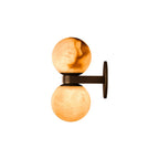 Side profile of the Clérachic Lush Twin Globe Wall Sconce, showing the flat bronze arm and round wall plate that carry the two stone globes.
