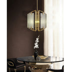 Clérachic chandelier over a round glass dining table, panels glowing beside a floor-length ivory curtain.
