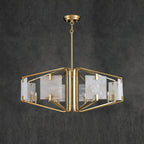 Clérachic chandelier against a slate backdrop, three-quarter view showing the brass frame's stepped tiers.