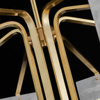Macro of the Clérachic chandelier's brass bar junction, showing the machined connector and fixing screw.