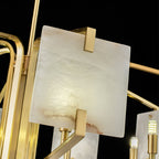 Detail of the Clérachic chandelier's panel corner in its brass bracket, with a G9 socket alongside it.
