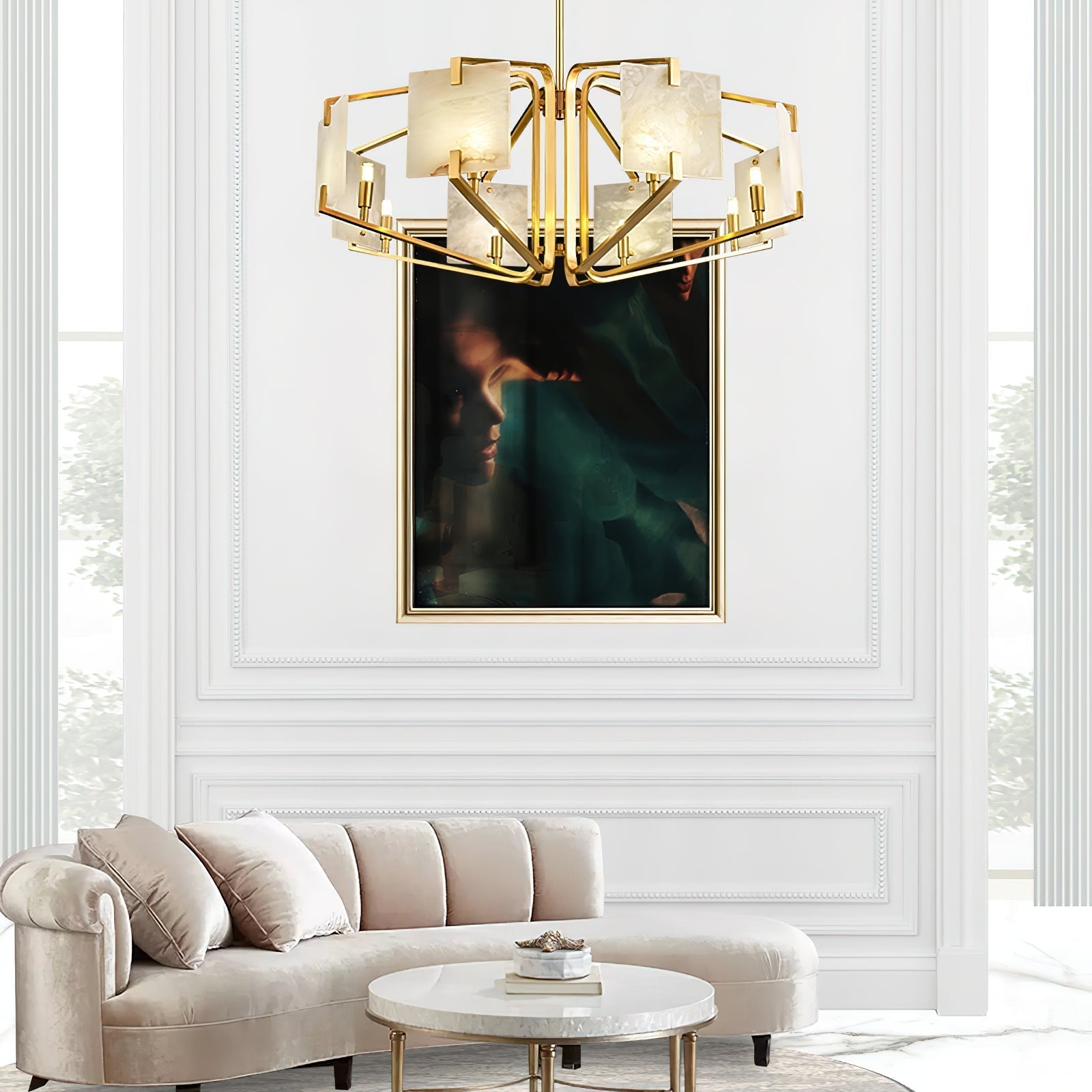 Clérachic chandelier in a white panelled room, hung above a curved cream sofa and round marble table.