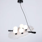 Clérachic Magma pendant, five opal globes set along a black bar across a natural alabaster disc.