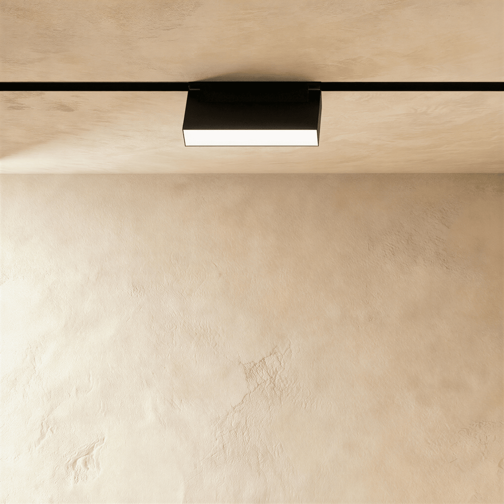 Clérachic box floodlight, a low black housing on the rail with a lit panel across its underside.