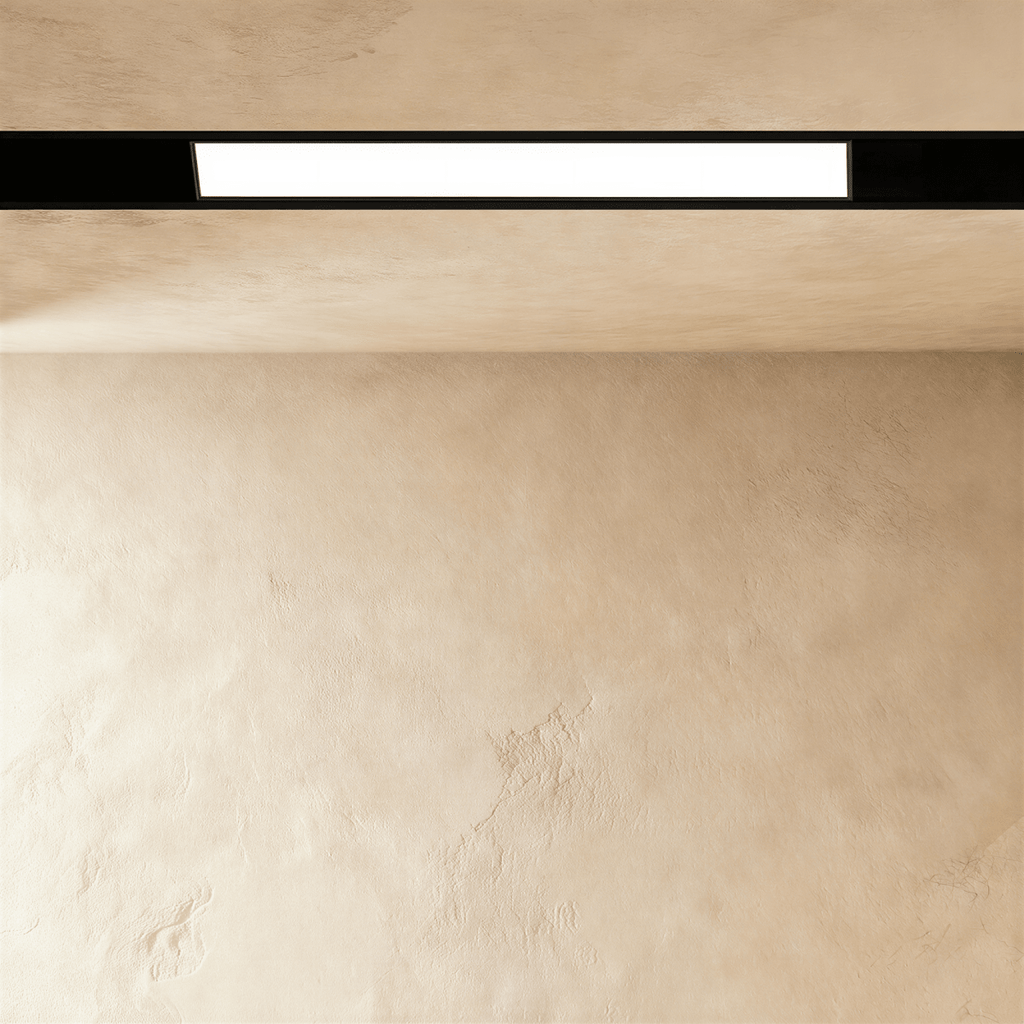 Clérachic recessed light bar along a limewashed ceiling, the lit panel framed in black above and below.