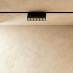 Clérachic surface-mounted grille box, six lenses in a low black housing standing below the rail.