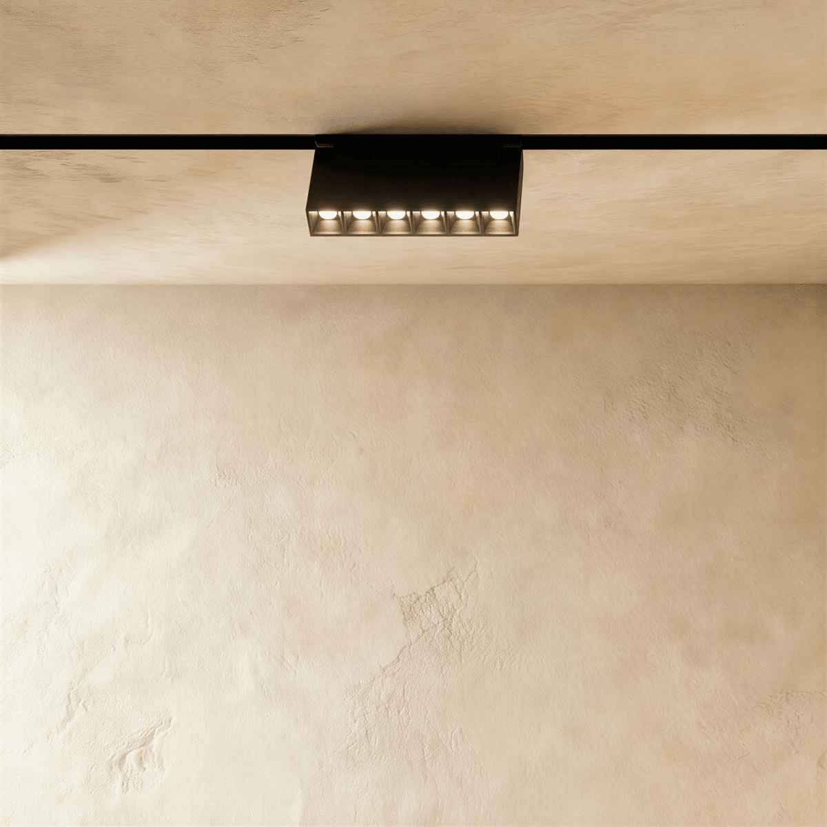 Clérachic surface-mounted grille box, six lenses in a low black housing standing below the rail.