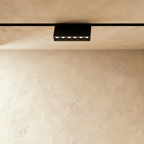 Clérachic surface-mounted grille box seen at an angle, the housing held clear of the ceiling on its bracket.