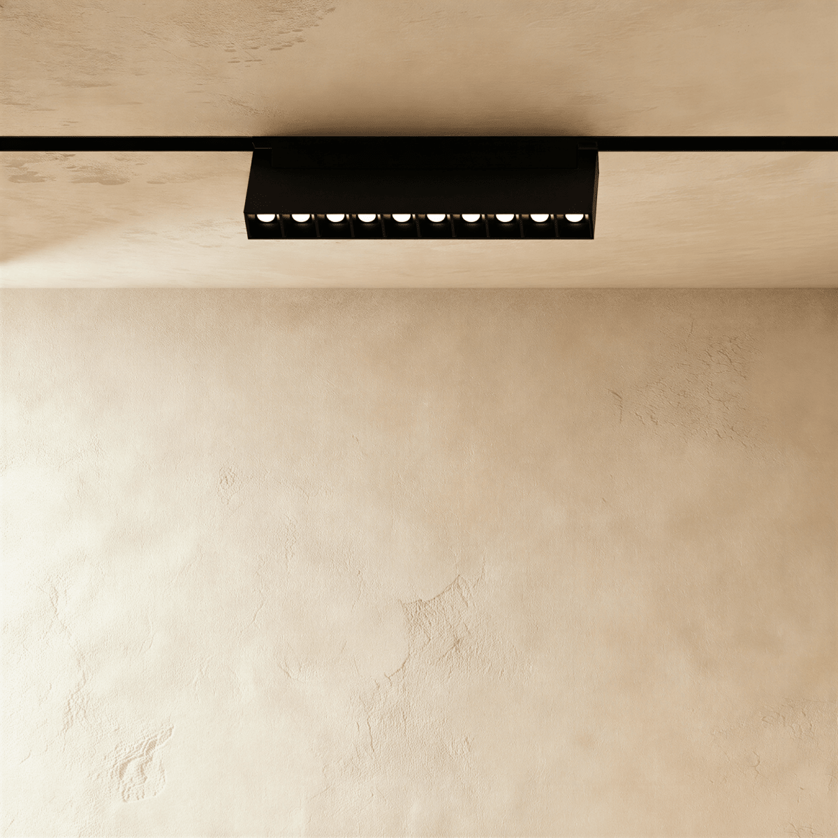 Clérachic surface-mounted grille box turned on the rail, the lit lenses running away from the camera.