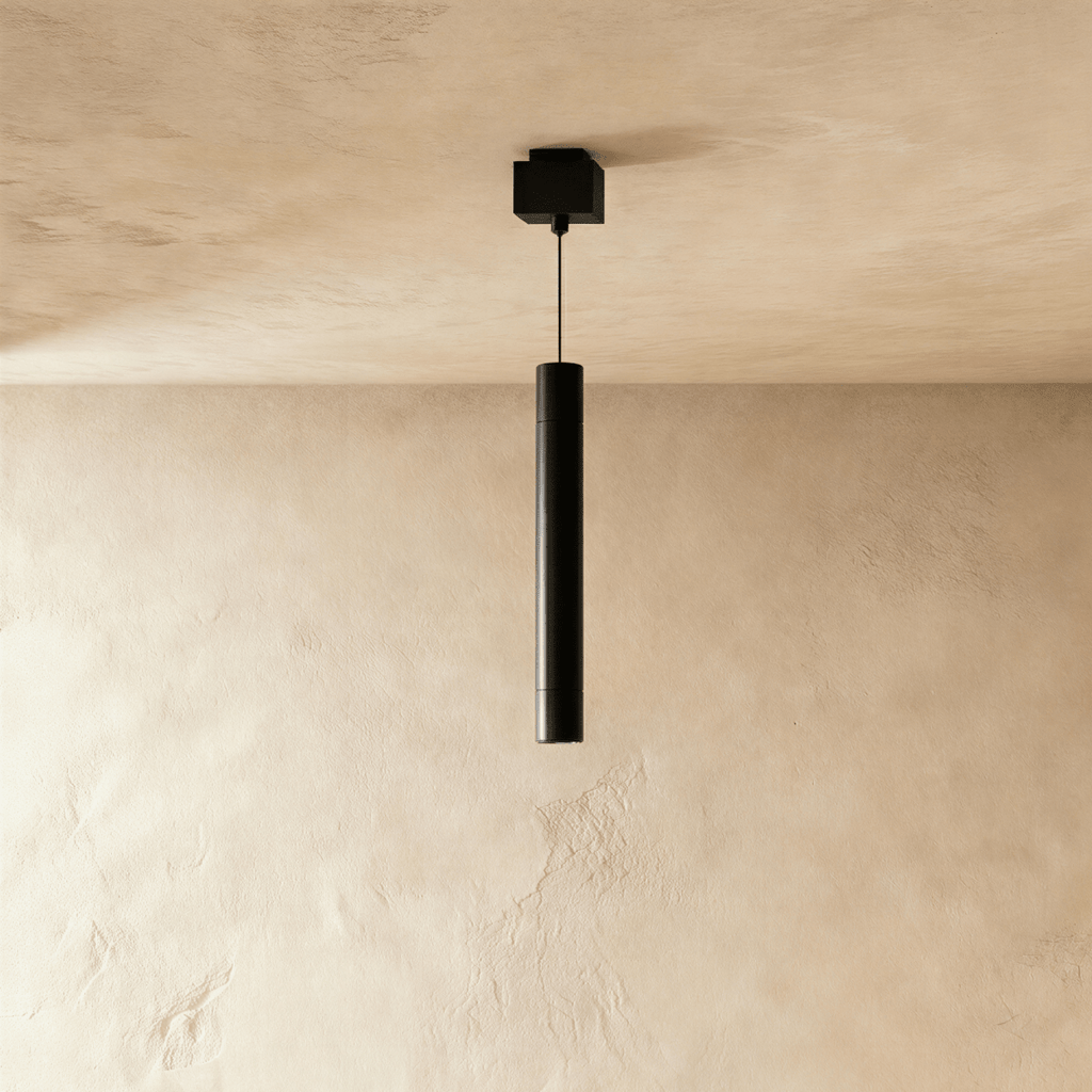 Clérachic pendant head, a slim black cylinder on a thin cable below a square black ceiling box.
