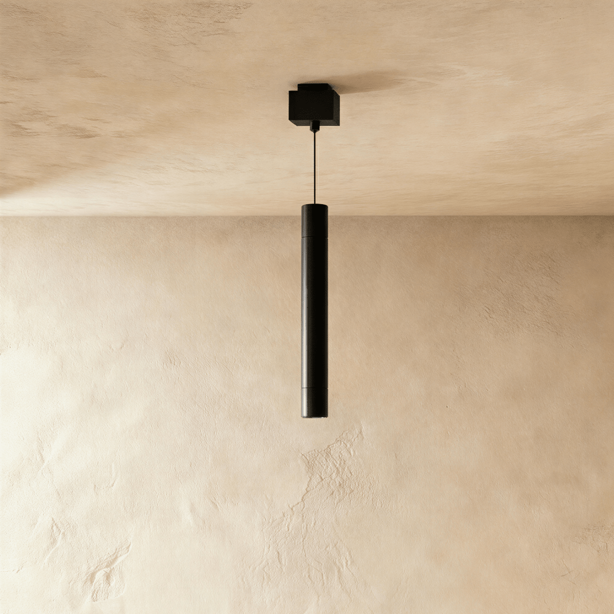 Clérachic pendant head, a slim black cylinder on a thin cable below a square black ceiling box.