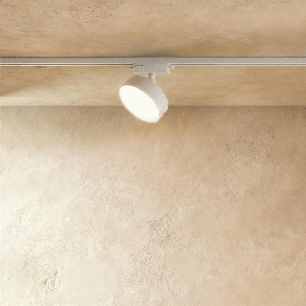 Clérachic white round track light head on a white rail, a little larger, tilted down with a glowing frosted face.