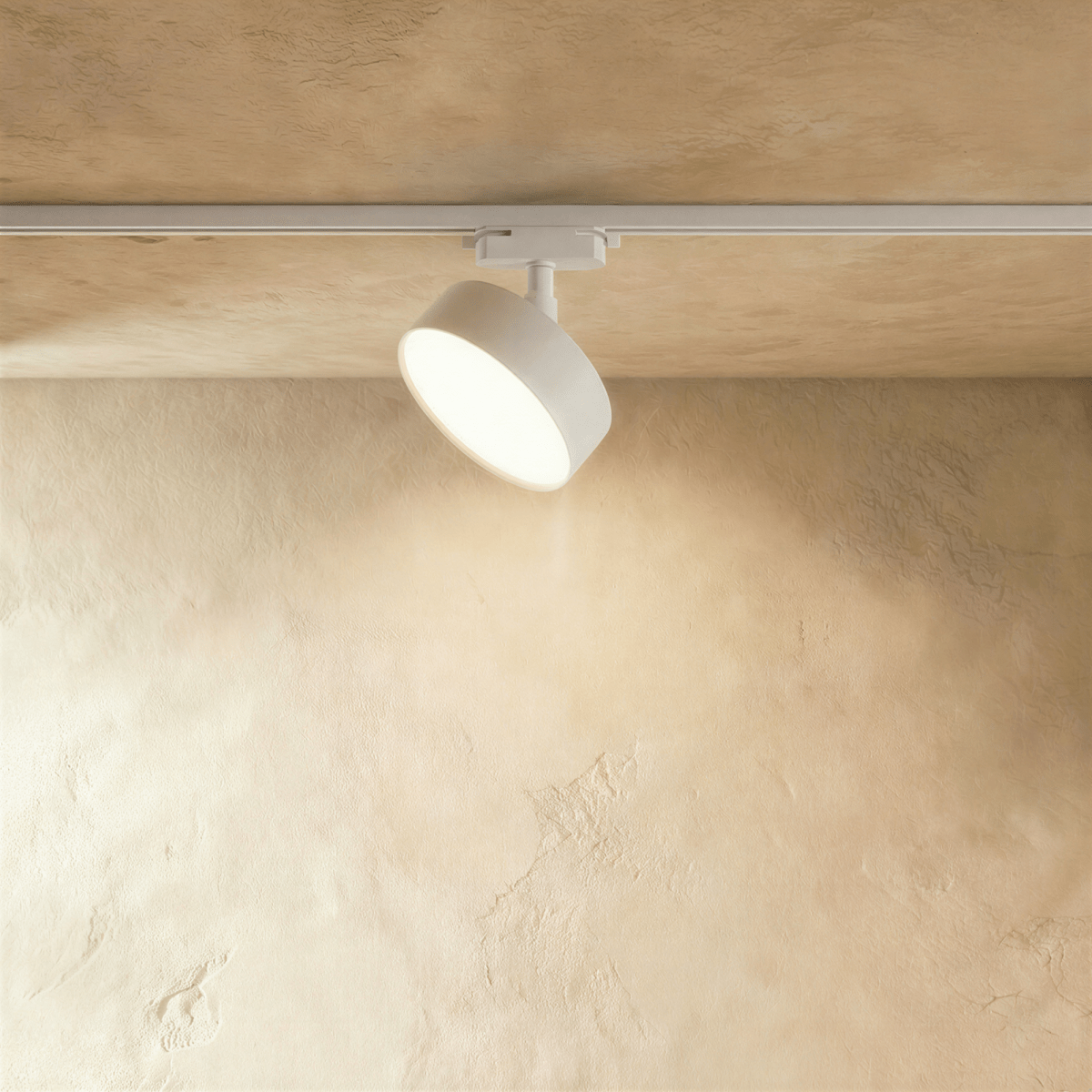 Clérachic widest white round track light head on a white rail, tilted to the wall with a bright frosted disc face.