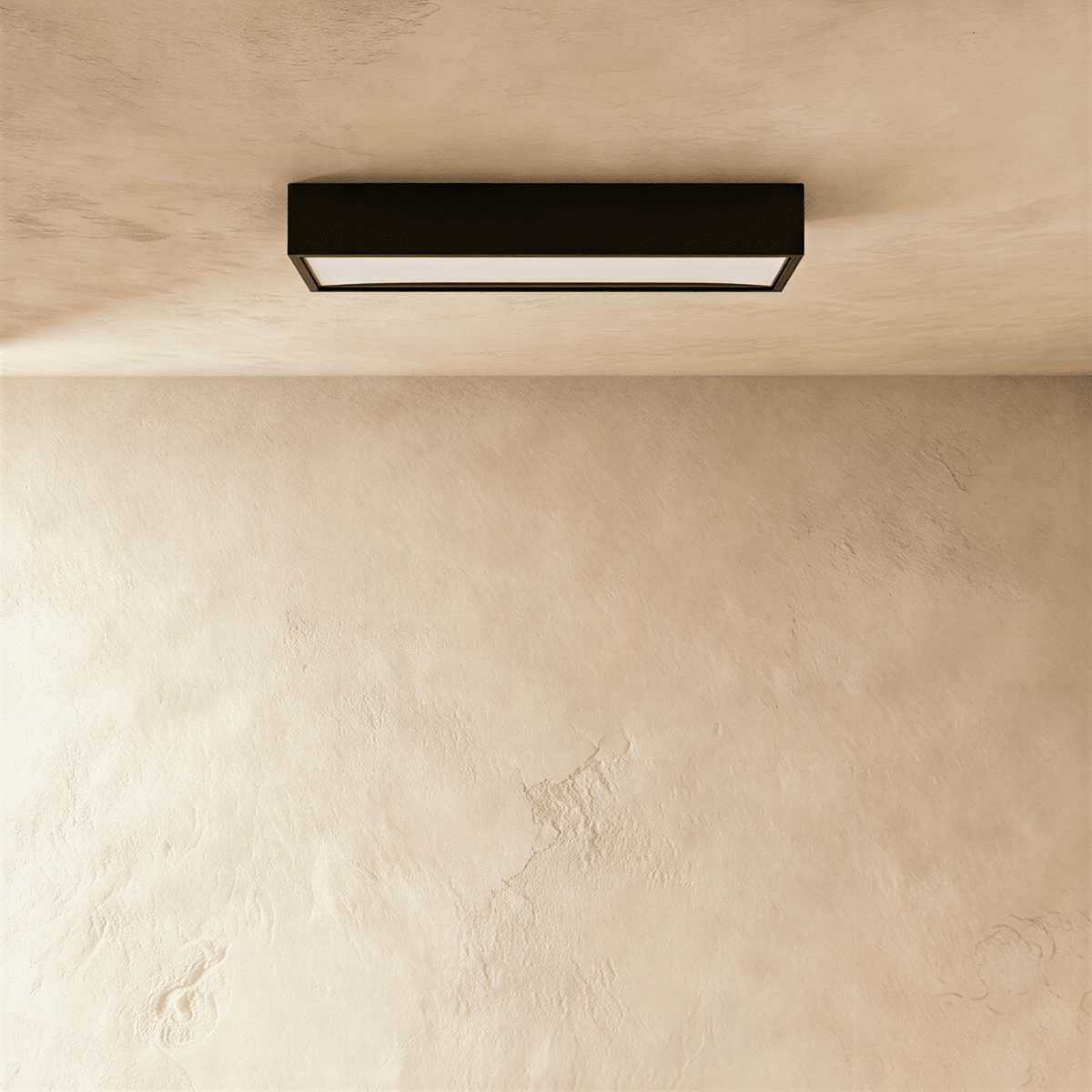 Clérachic slim black rectangular surface-mounted ceiling bar light with a frosted diffuser edge, fixed flat to a plaster ceiling.