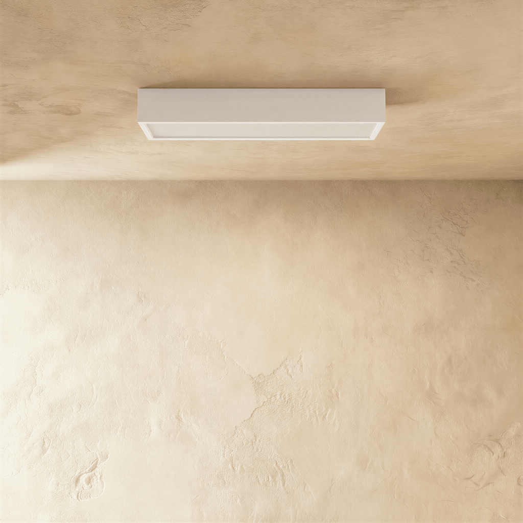Clérachic slim white rectangular surface-mounted ceiling bar light with a frosted diffuser edge, fixed flat to a plaster ceiling.