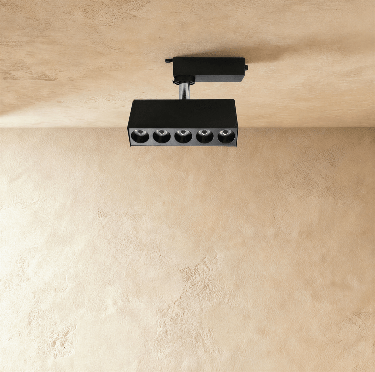 Clérachic black five-spot track spotlight bar with deep recessed round lenses, hanging from a track adaptor on a short stem.